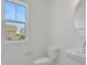 Bathroom with white fixtures and a round mirror at 196 Eagleston Ln, Lakewood Ranch, FL 34240