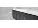 Modern bathroom boasts dual sinks with granite countertops, sleek dark wood cabinets and a glass shower at 196 Eagleston Ln, Lakewood Ranch, FL 34240
