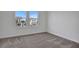 Empty bedroom showcasing plush carpet and a street view at 196 Eagleston Ln, Lakewood Ranch, FL 34240