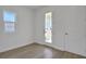 Bright bedroom with wood floors, a window, and a glass paneled door at 196 Eagleston Ln, Lakewood Ranch, FL 34240