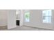 An open bedroom with neutral carpet, bright windows, and an ensuite bathroom and closet at 196 Eagleston Ln, Lakewood Ranch, FL 34240