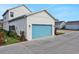 Detached two car garage with a blue door and exterior lighting at 196 Eagleston Ln, Lakewood Ranch, FL 34240
