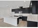 Modern kitchen featuring sleek, black cabinets and a white island at 196 Eagleston Ln, Lakewood Ranch, FL 34240