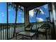 Relaxing balcony featuring comfortable seating and scenic lake views with lush palm trees at 7005 River Hammock Dr # 207, Bradenton, FL 34212