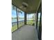 Screened balcony overlooking a lake with views of palm trees and the golf course at 7005 River Hammock Dr # 207, Bradenton, FL 34212