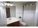 Neat bathroom with white shower curtain, vanity with sink, and white toilet at 7005 River Hammock Dr # 207, Bradenton, FL 34212