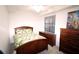 Cozy bedroom featuring a wooden bed frame and matching dresser for ample storage at 7005 River Hammock Dr # 207, Bradenton, FL 34212
