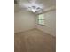 Comfortable bedroom with neutral carpet and a ceiling fan at 7005 River Hammock Dr # 207, Bradenton, FL 34212