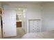 Cozy bedroom showcasing a dresser and ensuite bathroom access at 7005 River Hammock Dr # 207, Bradenton, FL 34212