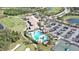 Aerial view of community clubhouse, pool, golf course, and parking at 7005 River Hammock Dr # 207, Bradenton, FL 34212