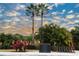 Exterior view of a community street with palm trees, landscaping, and clear signage at 7005 River Hammock Dr # 207, Bradenton, FL 34212