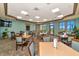 Cozy dining area with tables, chairs, and large windows offering scenic views at 7005 River Hammock Dr # 207, Bradenton, FL 34212