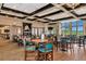 Well-lit dining room with multiple tables, chairs, and views of the beautiful outdoors at 7005 River Hammock Dr # 207, Bradenton, FL 34212