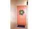 Charming unit entrance door adorned with a wreath, creating a welcoming atmosphere at 7005 River Hammock Dr # 207, Bradenton, FL 34212