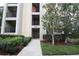 Inviting building exterior with manicured landscaping and well-maintained walkway to entrance at 7005 River Hammock Dr # 207, Bradenton, FL 34212