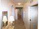 Bright hallway with tile floors, mirrors, and multiple doorways leading to different areas of the home at 7005 River Hammock Dr # 207, Bradenton, FL 34212