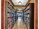 Elegant library hallway with floor-to-ceiling bookshelves and warm lighting at 7005 River Hammock Dr # 207, Bradenton, FL 34212