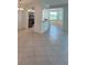 Open-concept living room featuring neutral tile flooring and views into the kitchen at 7005 River Hammock Dr # 207, Bradenton, FL 34212