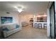 Bright, open-concept living room with tile floors, modern furniture, and a well-equipped kitchen at 7005 River Hammock Dr # 207, Bradenton, FL 34212
