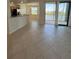 Spacious living room featuring neutral tile floors and access to a screened balcony at 7005 River Hammock Dr # 207, Bradenton, FL 34212