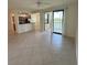 Bright living room with tile flooring and access to a screened balcony with lake views at 7005 River Hammock Dr # 207, Bradenton, FL 34212