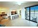 Open-concept living space featuring an adjacent kitchen, a desk space and access to the outdoor lanai at 7005 River Hammock Dr # 207, Bradenton, FL 34212