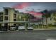 Convenient covered parking area beside a multi-story building under a colorful sky at 7005 River Hammock Dr # 207, Bradenton, FL 34212