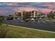 Ample parking area near a multi-story residential building at twilight at 7005 River Hammock Dr # 207, Bradenton, FL 34212