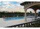 Inviting pool with decorative pillars and lounge chairs with tranquil views at 7005 River Hammock Dr # 207, Bradenton, FL 34212