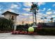 Tennis center with a tennis court, palm trees, and well-maintained landscaping at 7005 River Hammock Dr # 207, Bradenton, FL 34212