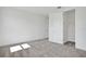 A bright bedroom features neutral carpet, white walls, closet and doors creating a blank canvas for personalization at 9015 Rothman Ln, Lakewood Ranch, FL 34240