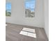 A bedroom bathed in sunlight shows two windows that offer views of the neighborhood from this carpeted room at 9015 Rothman Ln, Lakewood Ranch, FL 34240