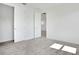 Bedroom with neutral carpet, closet and entry doors, and bright white walls creating a clean and minimalist aesthetic at 9015 Rothman Ln, Lakewood Ranch, FL 34240