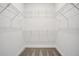 A spacious walk-in closet with carpet and installed shelving offers ample storage for clothes and accessories at 9015 Rothman Ln, Lakewood Ranch, FL 34240