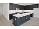 Modern kitchen with stainless steel appliances, white countertops, and dark cabinets at 9015 Rothman Ln, Lakewood Ranch, FL 34240