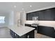 Contemporary kitchen boasts an island, stainless steel appliances, and sleek black cabinets at 9015 Rothman Ln, Lakewood Ranch, FL 34240