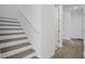 Bright staircase with white railings, light wood steps, and light wood flooring at 9015 Rothman Ln, Lakewood Ranch, FL 34240