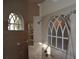 Modern shower featuring arched windows, glass blocks, and adjustable shower heads in a tiled surround at 13550 Thoroughbred Dr, Dade City, FL 33525