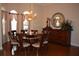 Dining room with hardwood floors, chandelier, and arched windows at 13550 Thoroughbred Dr, Dade City, FL 33525