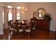 Dining room with hardwood floors, chandelier, and large windows at 13550 Thoroughbred Dr, Dade City, FL 33525