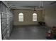 Spacious garage features an open door, two windows with blinds, and ample room for storage and vehicles at 13550 Thoroughbred Dr, Dade City, FL 33525