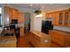 Well-lit kitchen with an island, wood cabinets, granite countertops, and modern appliances throughout the area at 13550 Thoroughbred Dr, Dade City, FL 33525
