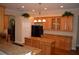 Bright kitchen featuring ample cabinetry, a center island, and stylish lighting fixtures at 13550 Thoroughbred Dr, Dade City, FL 33525