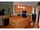 Spacious kitchen featuring wood cabinets, granite countertops, a large island and stainless steel appliances at 13550 Thoroughbred Dr, Dade City, FL 33525