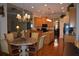 Open kitchen with wood cabinets, granite countertops, stainless steel appliances, and hardwood floors at 13550 Thoroughbred Dr, Dade City, FL 33525