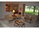 Warm living room with views to kitchen and dining area featuring seating, golf course view and neutral color palette at 13550 Thoroughbred Dr, Dade City, FL 33525