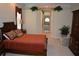 Comfortable main bedroom featuring an upholstered chair, carpet, and a glimpse into the large bathroom at 13550 Thoroughbred Dr, Dade City, FL 33525