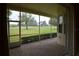 Screened patio offers golf course views, brick floors, and access to the outdoors for relaxation and entertainment at 13550 Thoroughbred Dr, Dade City, FL 33525