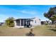 Spacious backyard features a screened patio, barbecue area, and well-maintained lawn at 8461 Buttonquail Dr, Englewood, FL 34224