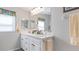 Bright bathroom features a double vanity, neutral walls, and modern fixtures at 8461 Buttonquail Dr, Englewood, FL 34224